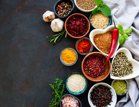 Various spices in a bowls on black concrete background. Top view copy space.の写真素材