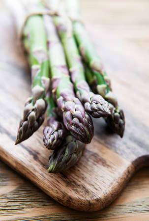 Fresh green asparagus on old wooden table.の写真素材