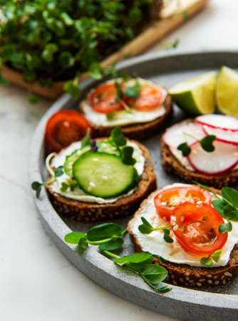 Sandwiches with healthy vegetables and micro greens on a white background