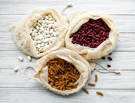 Zero waste concept. Eco bags with beans and pasta. Eco-shopping friendly and cooking concept, flat...