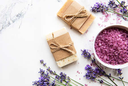 Natural organic SPA cosmetic with lavender. Flat lay bath salt and lavender flowers on marble...