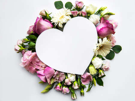 Creative layout with pink flowers and heart shape. Anniversary concept.Flat lay.の写真素材