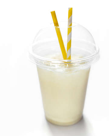 Pina colada alcoholic fresh cocktail served cold with coconut and banana on a white background
