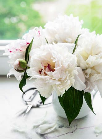 Beautiful pink peony bouquet in a vase. Spring mood, romantic present.の写真素材