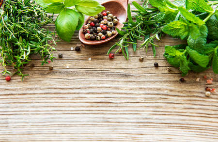Fresh herbs and spices on wooden background top viewの写真素材