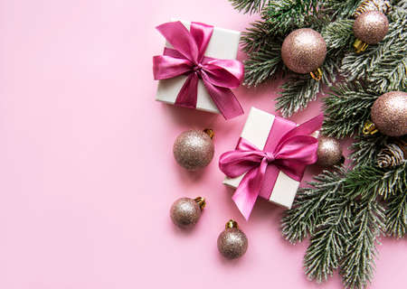 Christmas composition. Christmas gifts, pink decorations on pastel pink background. Flat lay, top view, copy spaceの写真素材