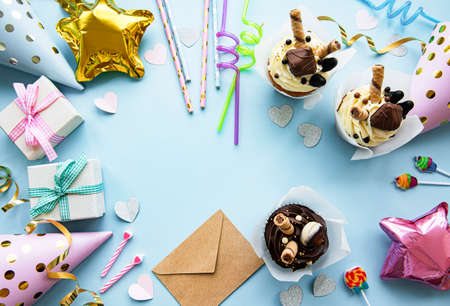 A top down view of common birthday party items in a border frame.