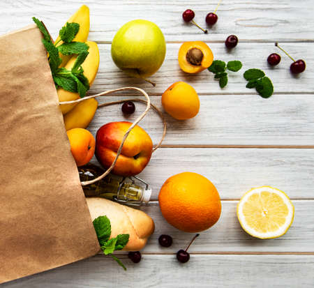 Healthy food background. Healthy food in paper bag, fruits and berriesの写真素材
