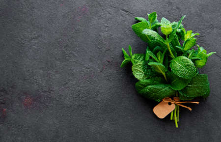 Fresh mint leaves herb on stone table. Top view