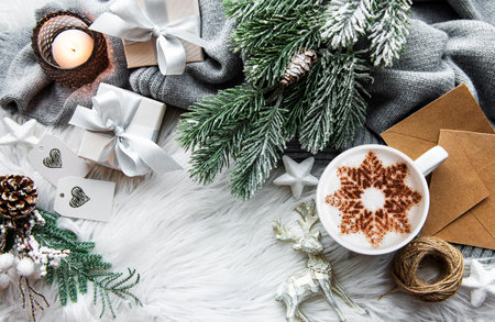 Coffee with a snowflake pattern and Christmas decorations, top view, cozy winter conceptの写真素材