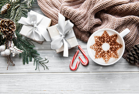 Coffee with a snowflake pattern and Christmas decorations, top view, cozy winter conceptの写真素材