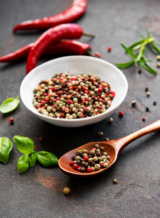 Red hot chili pepper corns and pods on dark background, top viewの写真素材