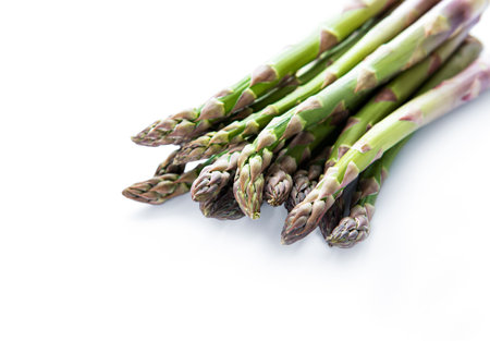 Fresh green asparagus on a white backgroundの写真素材
