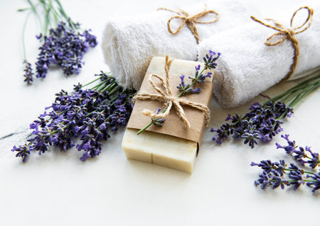 Spa setting with natural soap, towels and lavender on a marble backgroundの写真素材