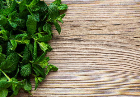 Fresh mint leaves on old wooden background