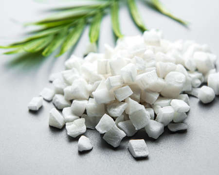 Dried sweet coconut cubes on a white background.の写真素材