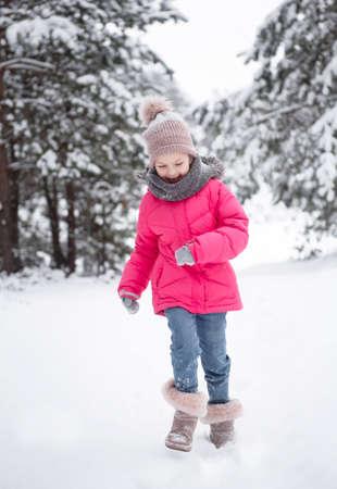 Child in winter. A little girl, playing in the winter outside. A beautiful winter child portrait. Happy child, winter fun outdoor.の写真素材
