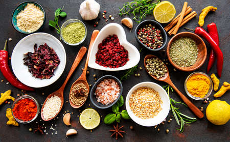 Various spices in a bowls on black concrete background. Top view copy space.の写真素材