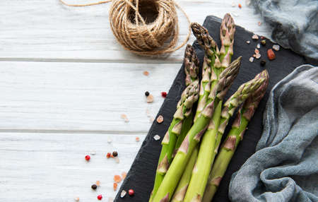 Fresh green asparagus on old wooden table. Flat layの写真素材