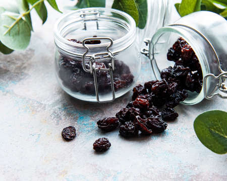 Dried grapes, raisins on a gray concrete
