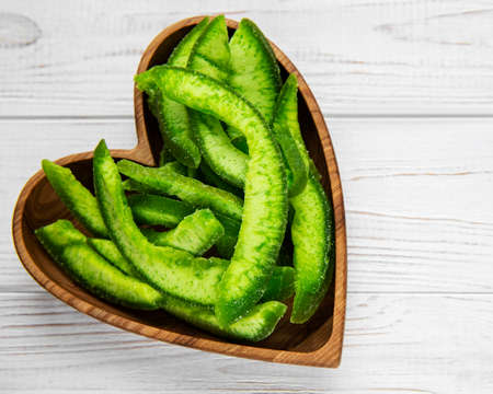 Dry chunks of pomelo on a plate on a white wooden backgroundの写真素材