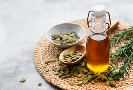 Bottle with pumpkin seed oil on gray concrete backgroundの写真素材