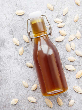 Bottle with pumpkin seed oil on gray concrete backgroundの写真素材