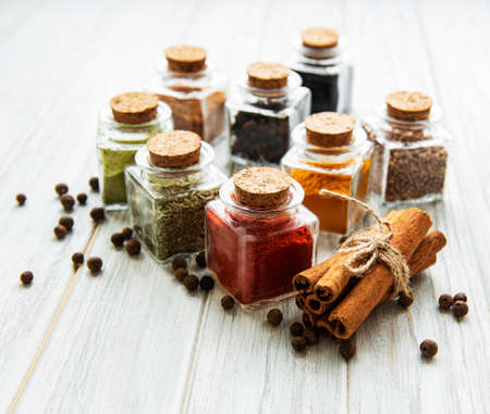 Jars with dried herbs, spices on the tableの写真素材