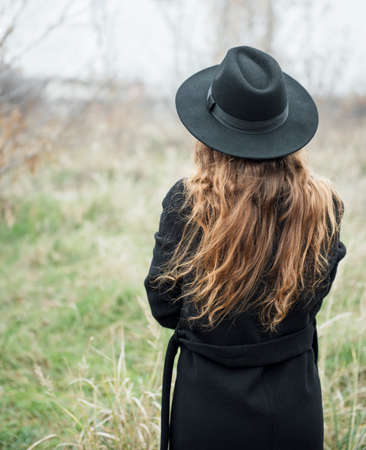 Portrait of young attractive woman in black coat and hat.の写真素材
