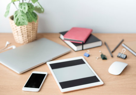 Office workplace with laptop on wooden tableの写真素材