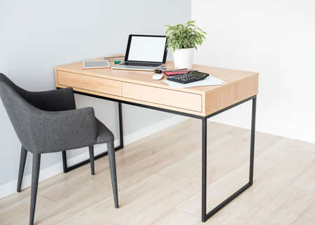 Office workplace with laptop on wooden tableの写真素材
