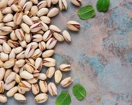 Pistachios nuts on a gray concrete backgroundの写真素材