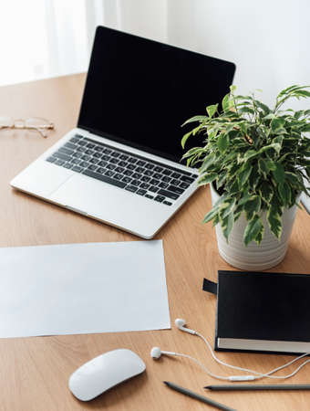 Office workplace with laptop on wooden tableの写真素材