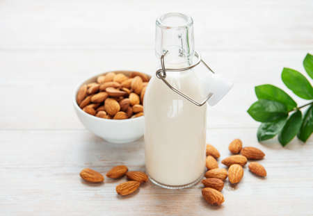 Bottles with almond milk and almonds on the tableの写真素材