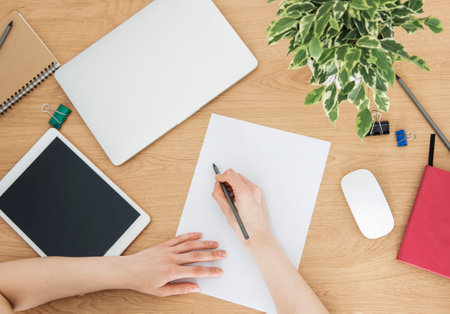 Young girl working at home office at the tableの写真素材
