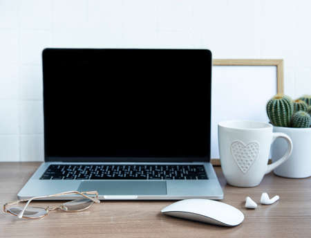 Office desktop. Laptop with office supplies on the table.の写真素材