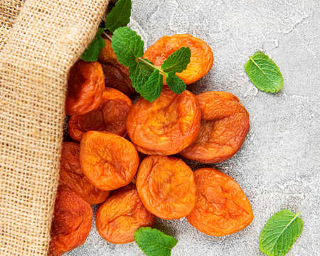 Dried apricots on a gray concrete background