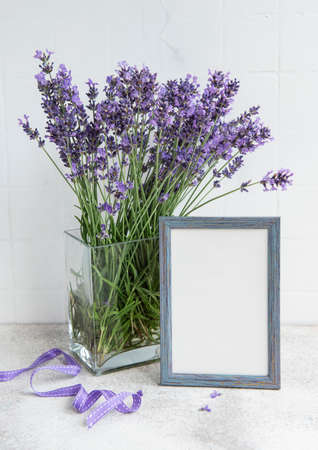 A bouquet of lavender in the interior of a kitchen. Frame mockup on a table.の写真素材