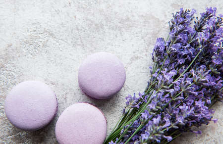 French macarons with lavender flavor and fresh lavender flowers on a concrete backgroundの写真素材