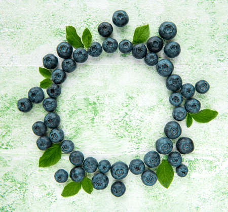 Freshly picked blueberries on a green wooden background. Concept for healthy eatingの写真素材