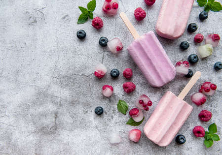 Homemade raspberry and blueberry ice cream and fresh raspberries. Summer food.の写真素材