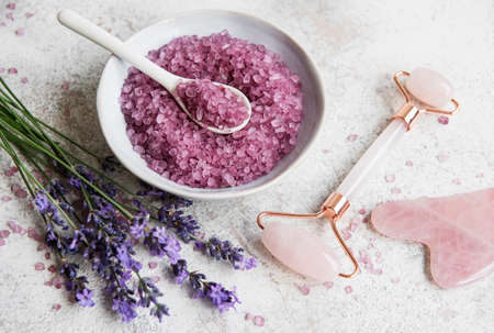Set of natural organic SPA cosmetic with lavender. Flat lay bath salt and face roller, on marble background. Skin care, beauty treatment conceptの写真素材