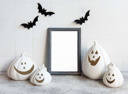 Mock up frame with Jack o Lantern and pumpkin decor on a table. Halloween concept. Poster frame...