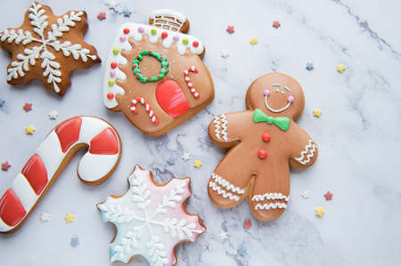 Christmas gingerbread cookies on a white marble background. Homemade delicious Christmas gingerbreadの写真素材