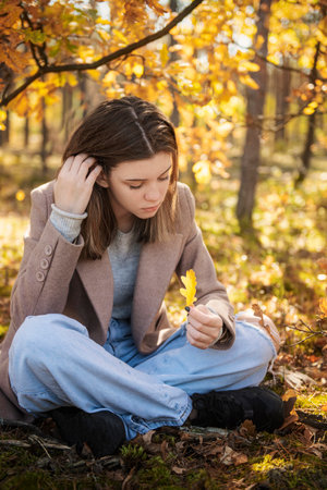 Young teenager girl in the autumn forest. Autumn colors. Lifestyle. Autumn mood. Forestの写真素材