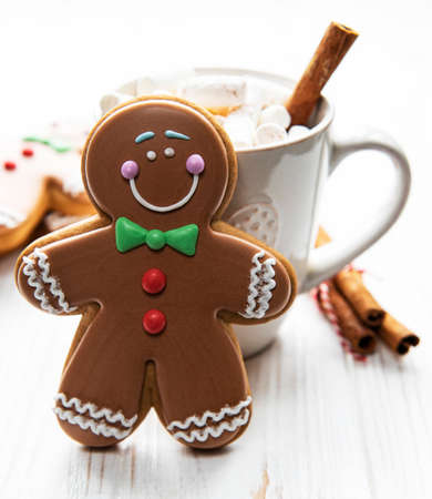 Homemade hot chocolate mug and gingerbread cookie on Christmas tableの写真素材