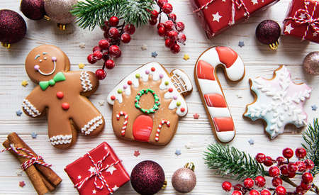 Christmas gingerbread with christmas decorations on white wooden table. Christmas holiday backgroundの写真素材