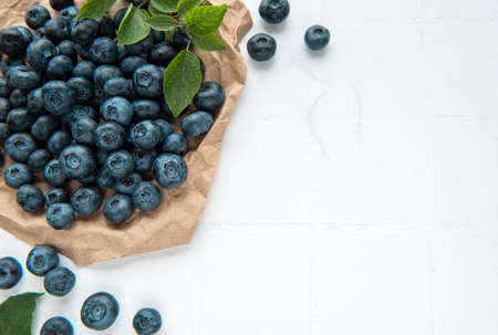 Freshly picked blueberries on a white tile background. Concept for healthy eatingの写真素材