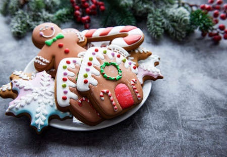 Christmas gingerbread in the plate and holiday decorationsの写真素材