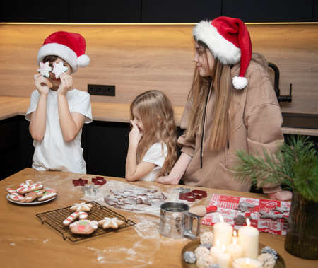 Getting ready for the Christmas holidays. Children are preparing gingerbread in the kitchenの写真素材